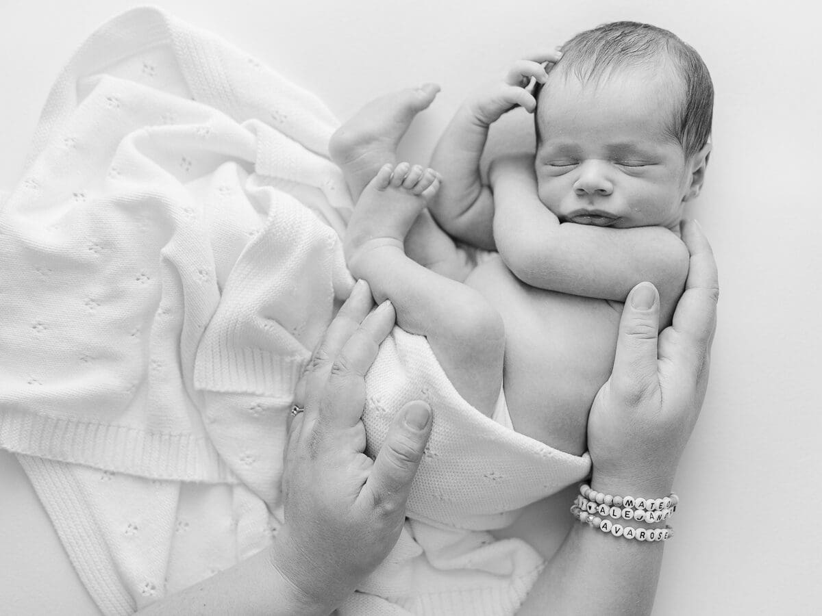 Sleeping newborn baby captured with soft studio lighting during a professional newborn session