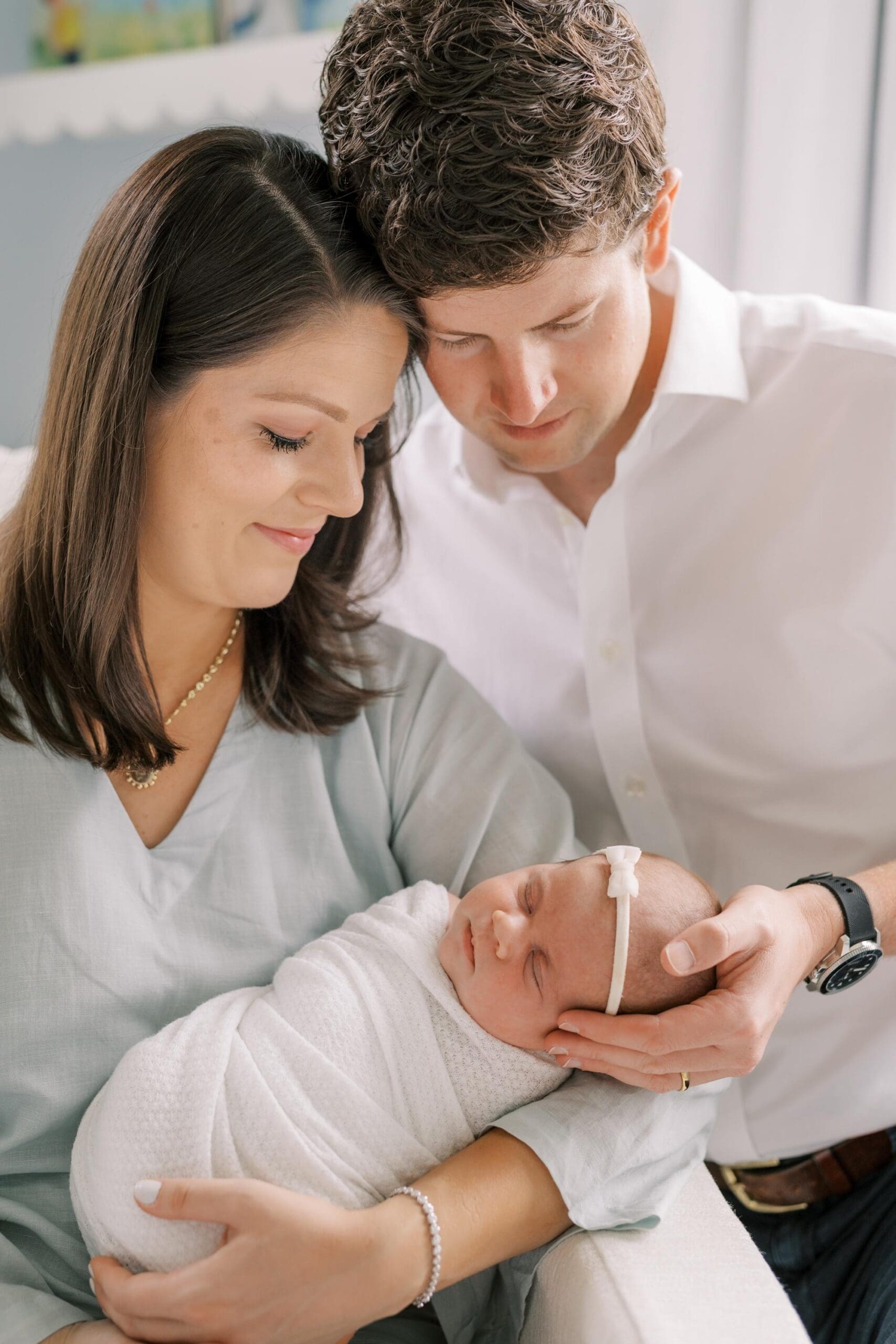 Columbia SC newborn photography featuring parents gently bonding with their newborn baby